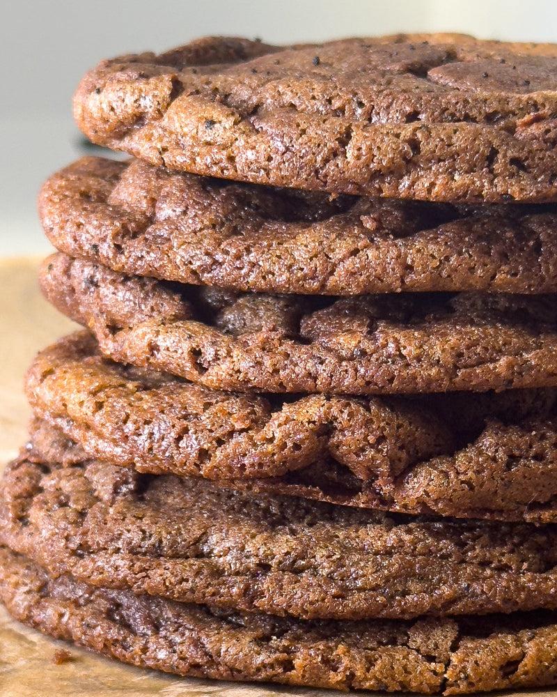 Stack of chocolate cookies on a wooden surface